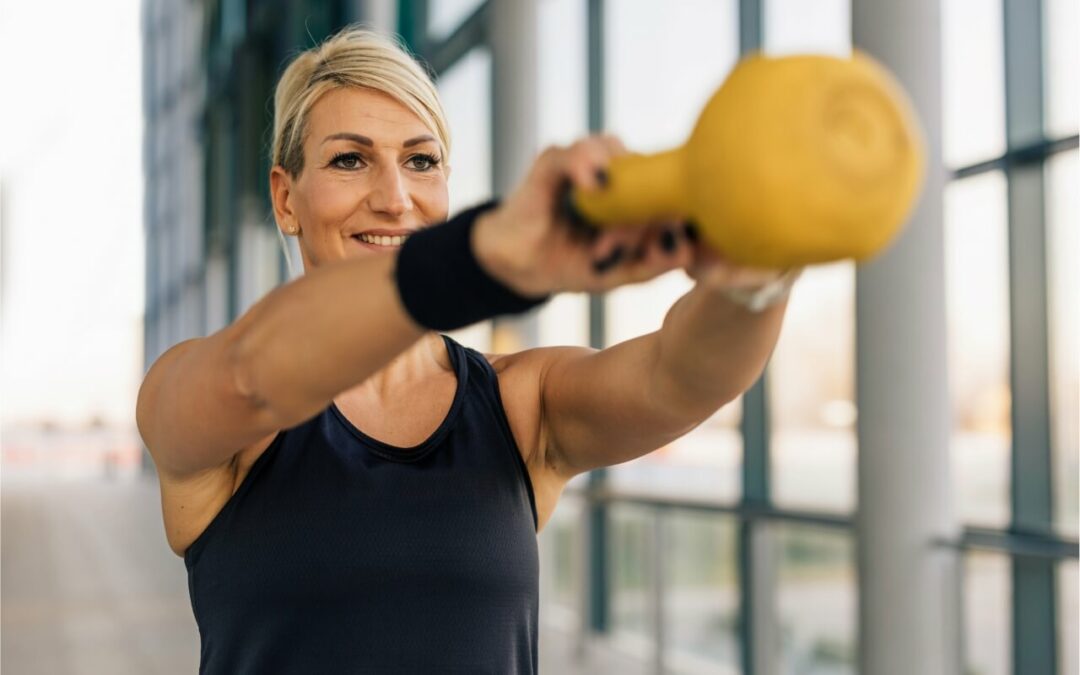 Smiling woman strength training with a kettlebell as a weapon against type 2 diabetes