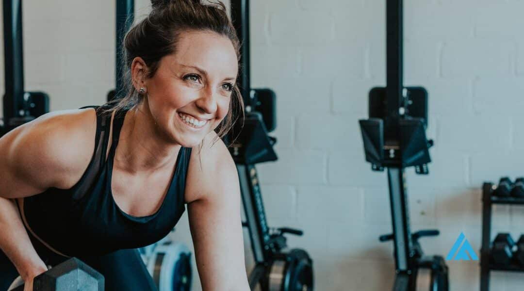 A joyful woman in her 50s smiling during a semi-private training session at Ignite Fitness and Nutrition, demonstrating the transformative power of personalised fitness over 45.
