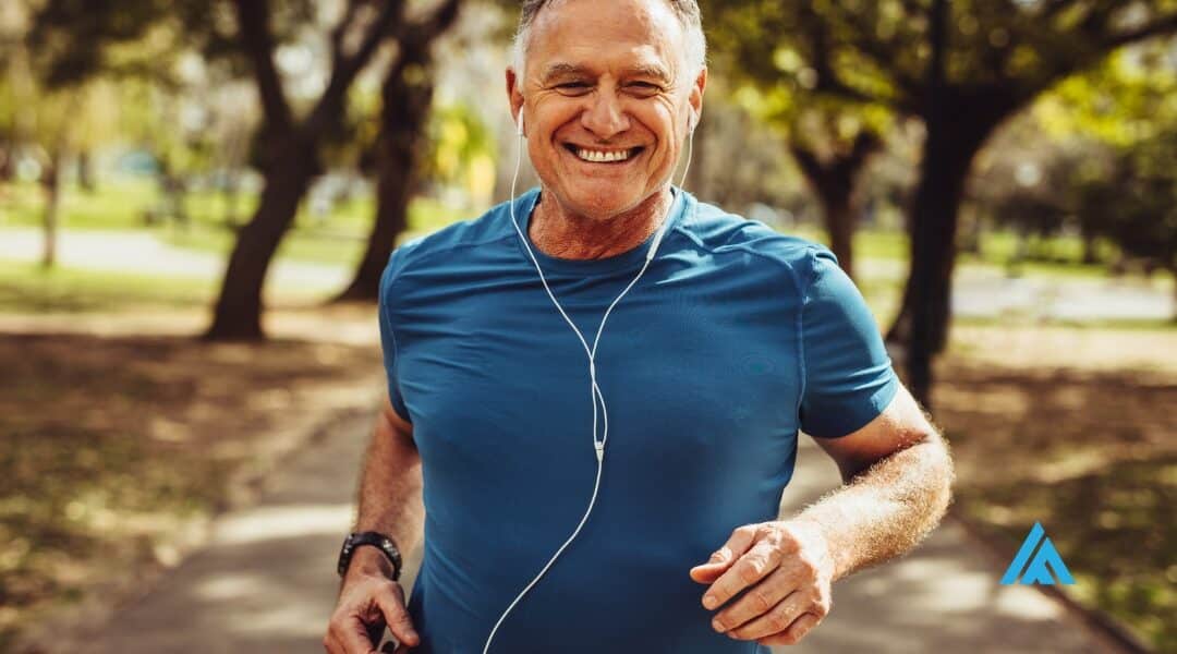 Senior man running with a smile, listening to music - epitomizing strength and stamina after 50